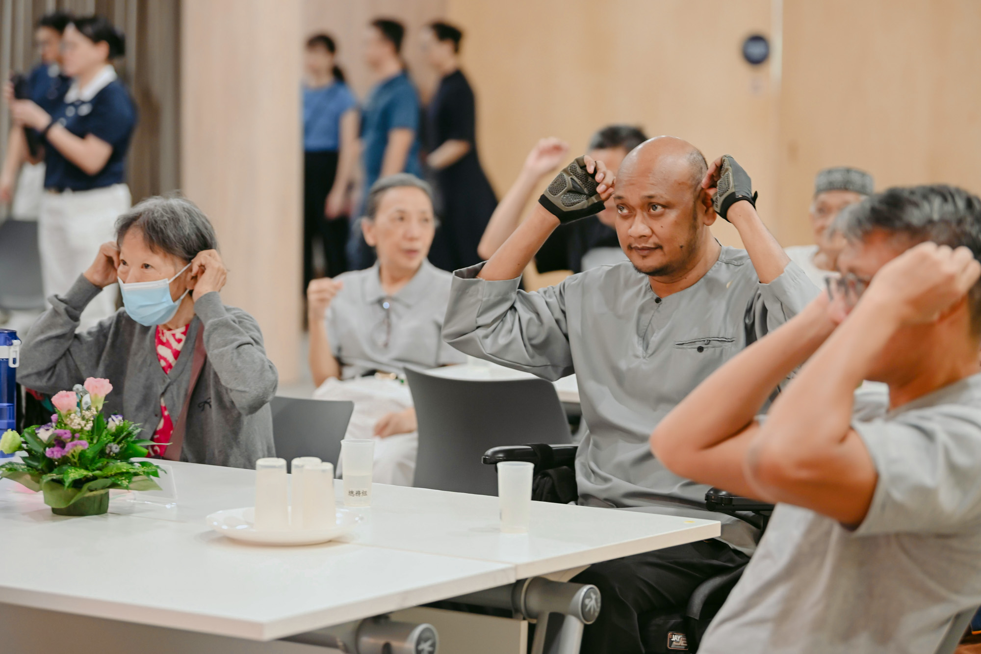 Participants paying close attention as they learn how to do ear acupoint massage. (Photo by Chai Yu Leong)